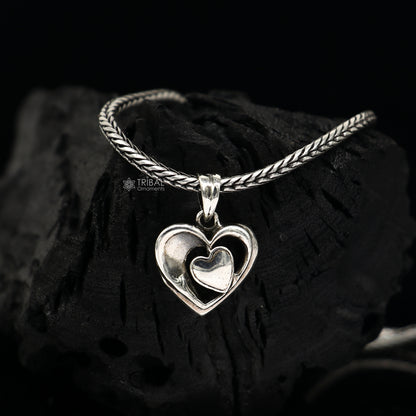 Sterling silver heart pendant necklace by TRIBAL ORNAMENTS, unisex jewelry with a unique design, perfect for gifting.