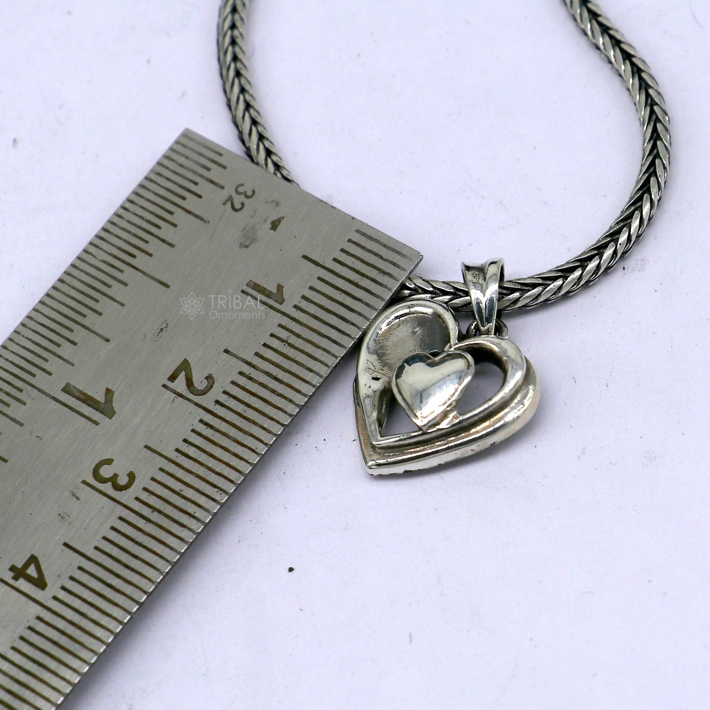 Sterling silver heart pendant necklace by Tribal Ornaments, unisex jewelry with a unique design, perfect for gifting or everyday wear.