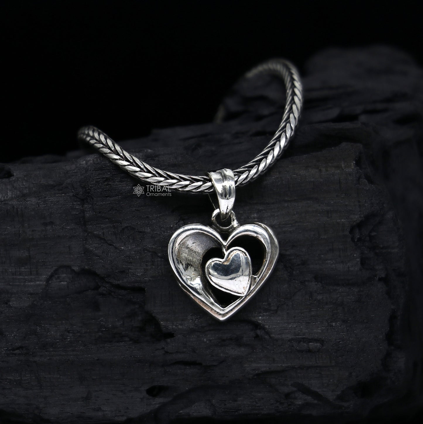 Sterling silver heart pendant necklace by TRIBAL ORNAMENTS, unisex jewelry with a unique design, perfect for gifting.
