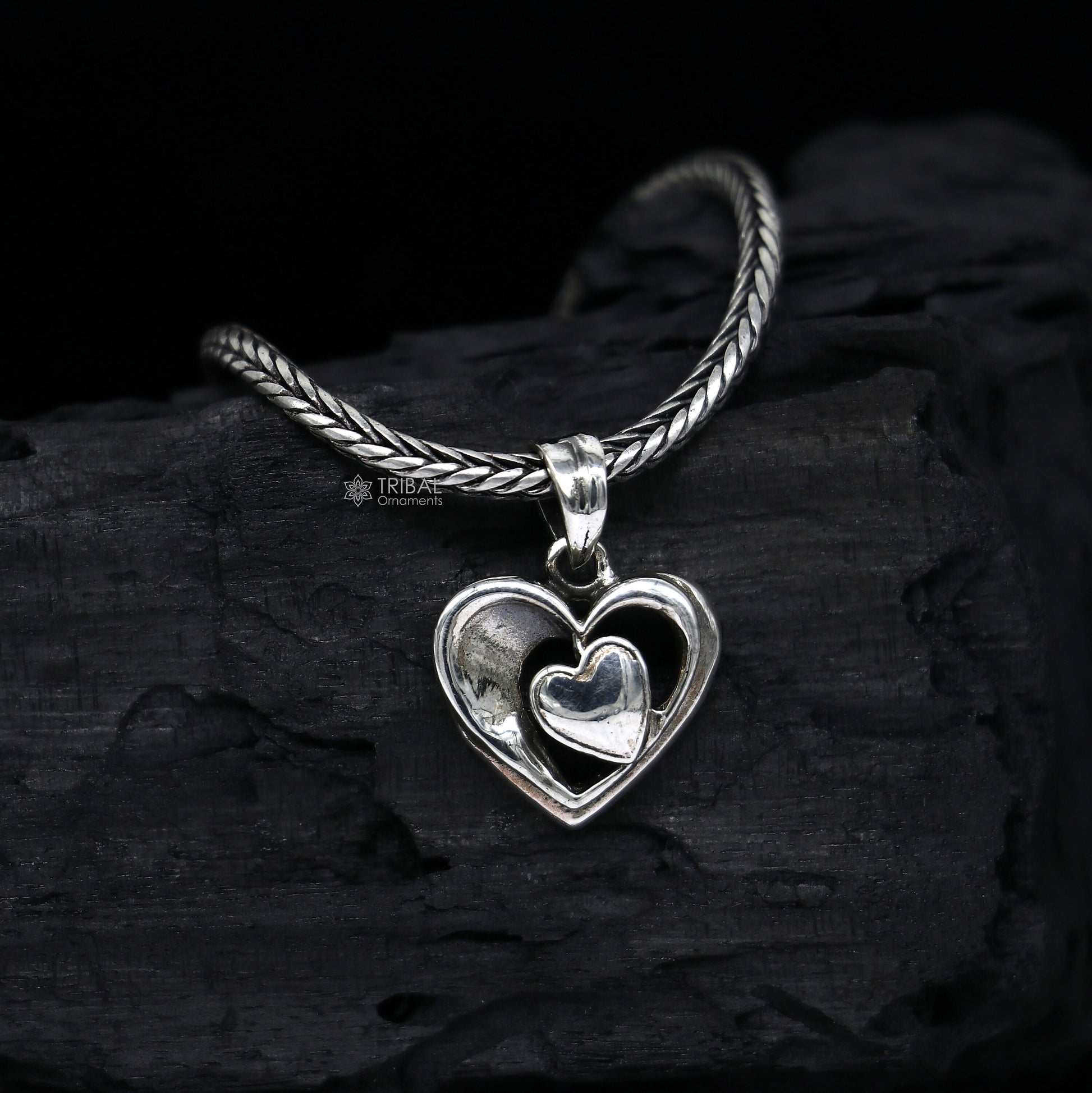 Sterling silver heart pendant necklace by TRIBAL ORNAMENTS, unisex jewelry with a unique design, perfect for gifting.