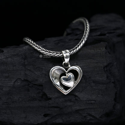 Sterling silver heart pendant necklace by TRIBAL ORNAMENTS, unisex jewelry with a unique design, perfect for gifting.