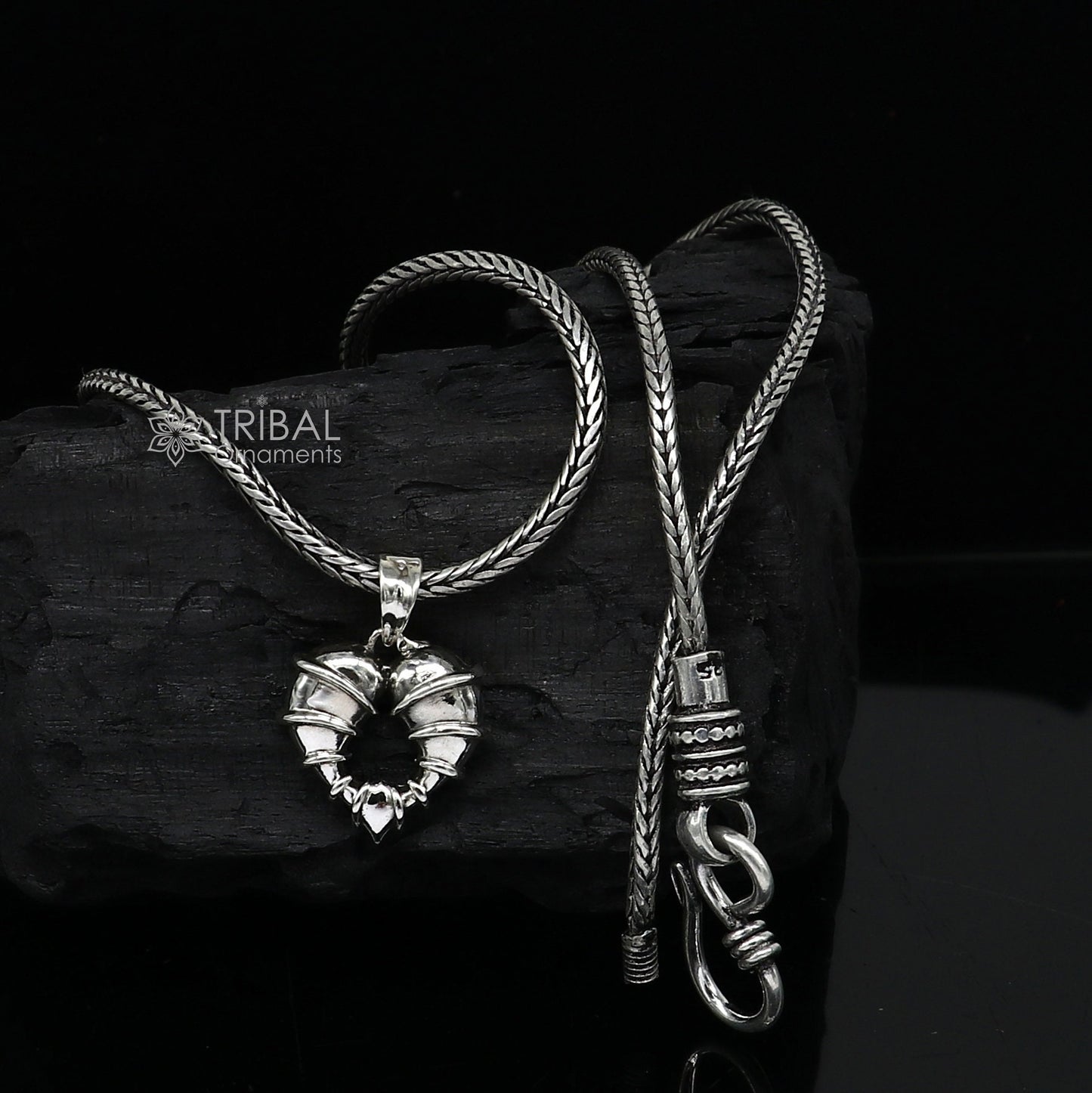 Sterling silver heart-shaped pendant necklace by Tribal Ornaments, featuring a unique design perfect for gifting jewelry.