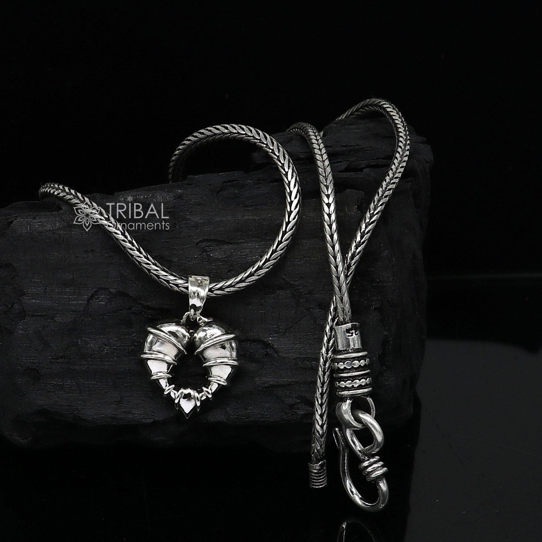 Sterling silver heart-shaped pendant necklace by Tribal Ornaments, featuring a unique design perfect for gifting jewelry.