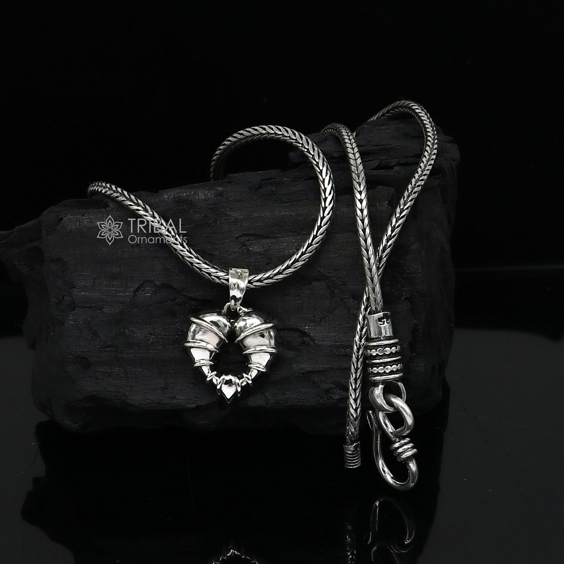 Sterling silver heart-shaped pendant necklace by Tribal Ornaments, showcasing a unique design perfect for gifting jewelry.