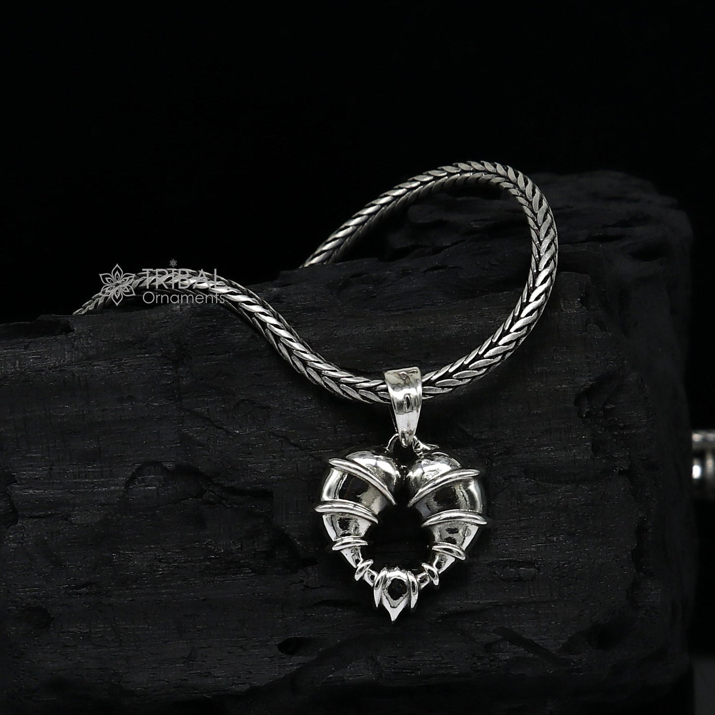 Sterling silver heart-shaped pendant necklace by Tribal Ornaments, featuring a unique design perfect for gifting jewelry.