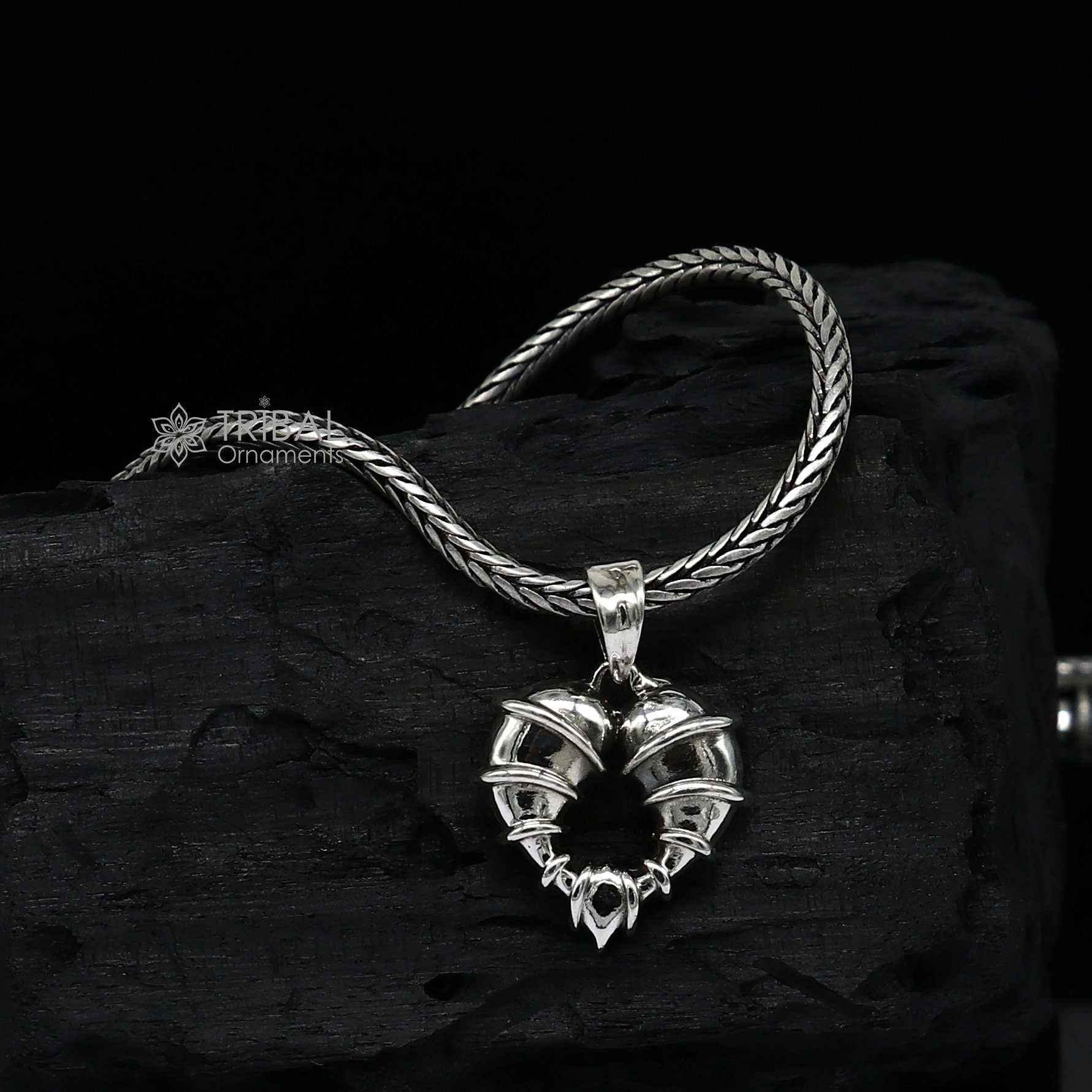 Sterling silver heart-shaped pendant necklace by Tribal Ornaments, featuring a unique design perfect for gifting jewelry.