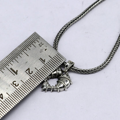 Sterling silver heart-shaped pendant necklace by TRIBAL ORNAMENTS, featuring a unique design perfect for gifting jewelry.