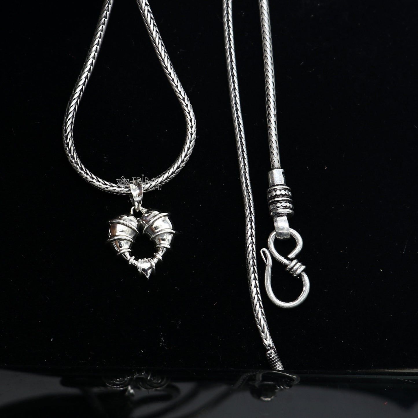 925 sterling silver heart-shaped pendant necklace by Tribal Ornaments, featuring a unique design and elegant locket style.