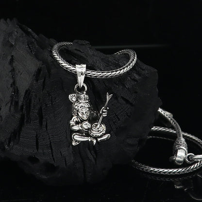Sterling silver Lord Krishna Makhan Gopala pendant on a delicate necklace, featuring intricate tribal-style jewelry design.