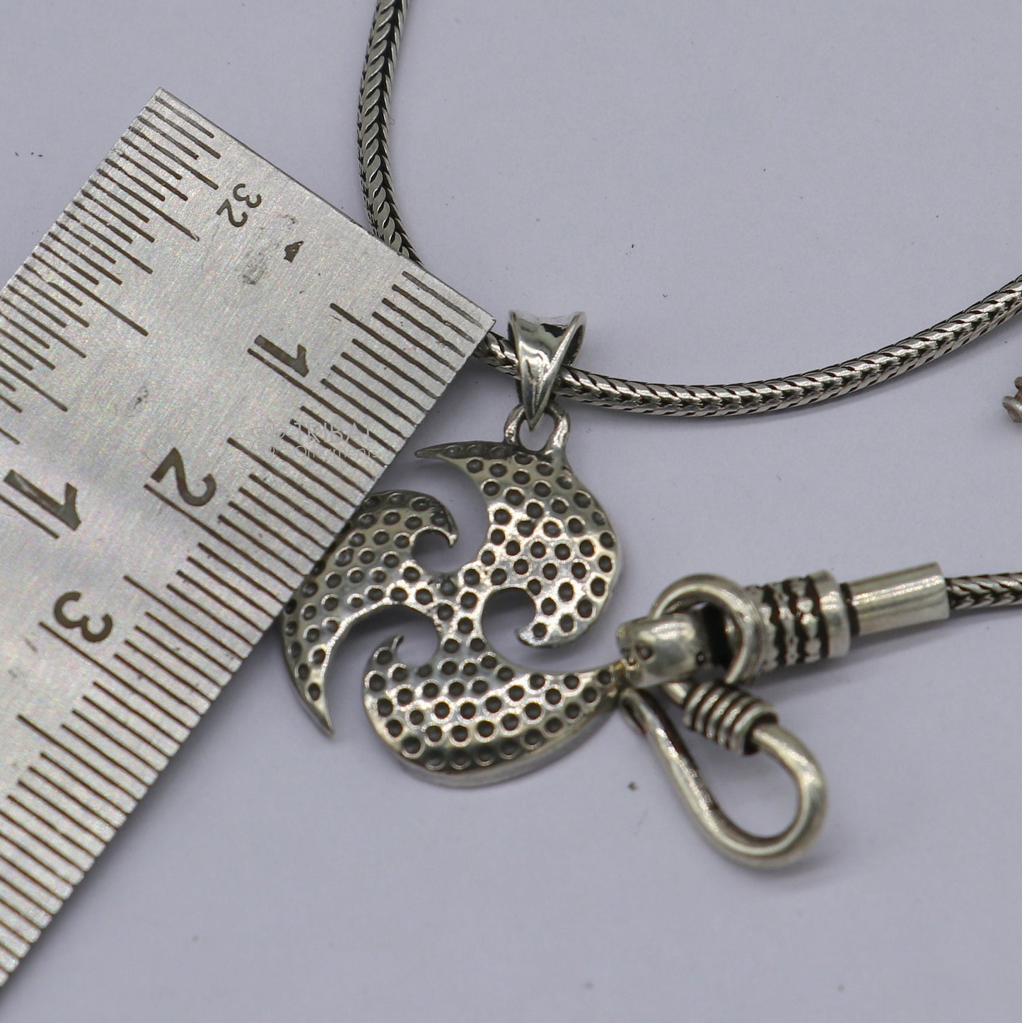 Sterling silver Ninza design Triskelion pendant by Tribal Ornaments, showcasing detailed handmade craftsmanship for boys and girls.