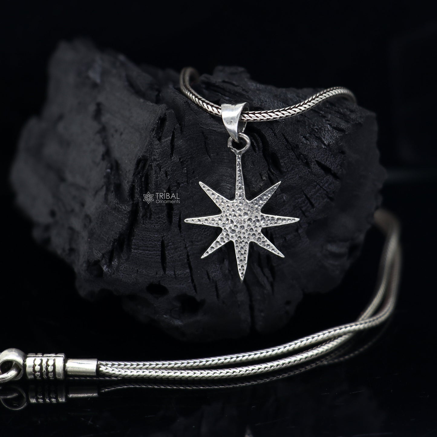 Sterling silver star pendant for boys and girls by TRIBAL ORNAMENTS, handmade, stylish jewelry accessory with a small, detailed design.
