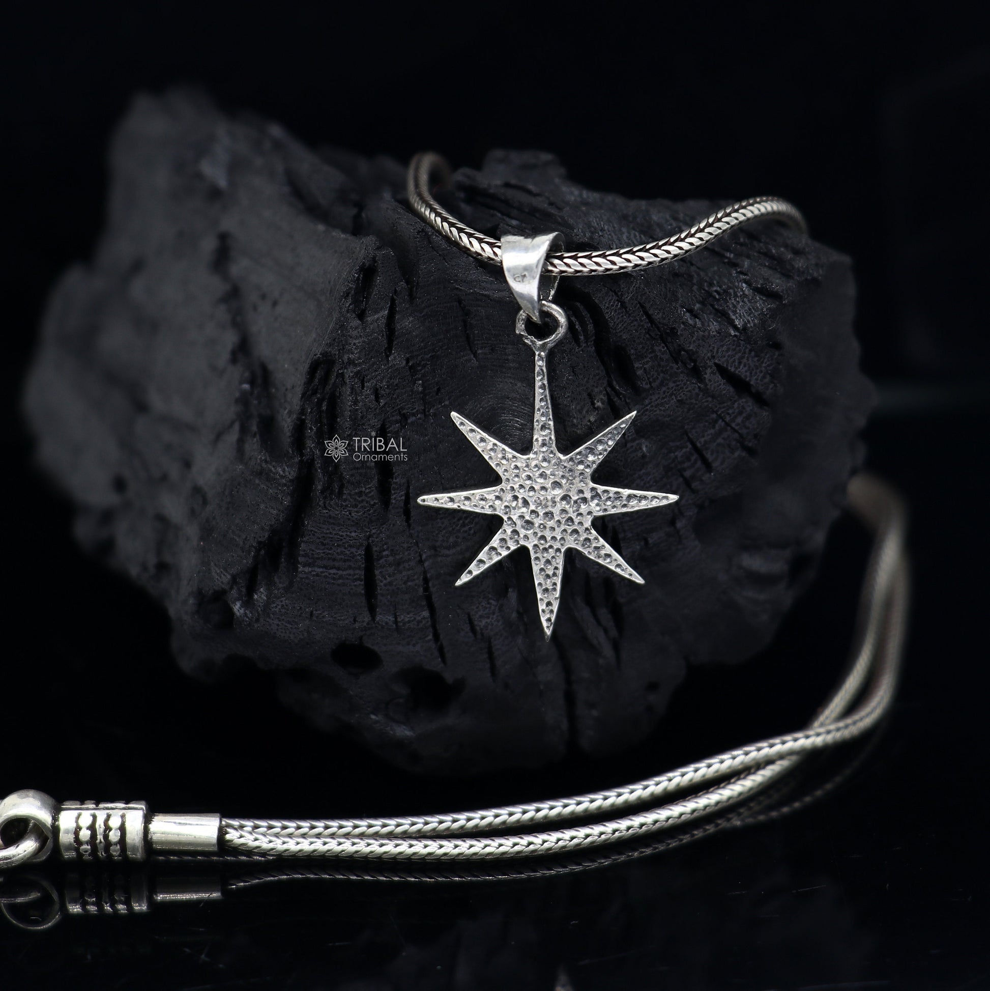 Sterling silver star pendant for boys and girls by TRIBAL ORNAMENTS, handmade, stylish jewelry accessory with a small, detailed design.