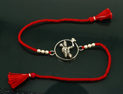 925 sterling silver Hanuman design bracelet with red thread Rakhi, crafted by Tribal Ornaments, featuring intricate idol and bracelet details.