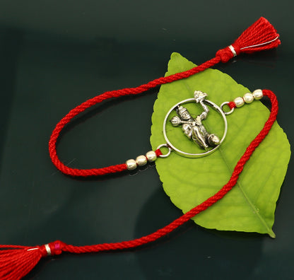 925 sterling silver Hanuman design bracelet with red thread rakhi, featuring intricate tribal ornament craftsmanship and traditional style.