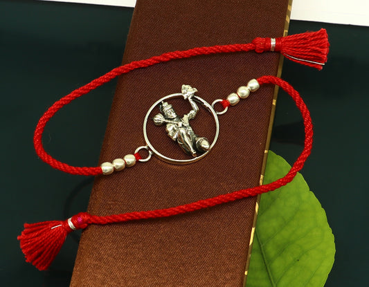 Sterling silver Hanuman bracelet with red thread Rakhi from Tribal Ornaments, featuring intricate god Hanuman design.