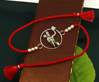 Sterling silver Hanuman bracelet with red thread Rakhi, featuring intricate tribal design by Tribal Ornaments, model RK172.