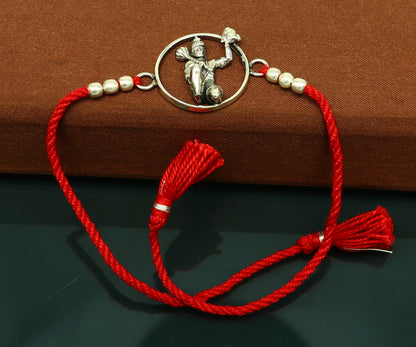Sterling silver Hanuman bracelet with red thread rakhi from Tribal Ornaments, featuring a detailed idol design.