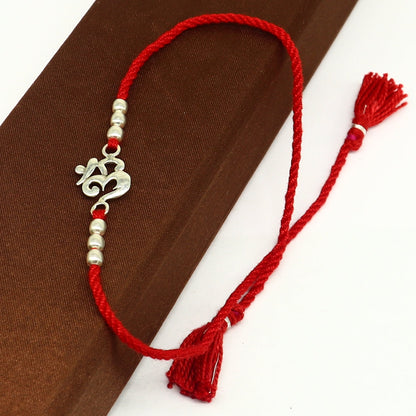 925 sterling silver OM symbol bracelet with red thread, custom design tribal rakhi by Tribal Ornaments.
