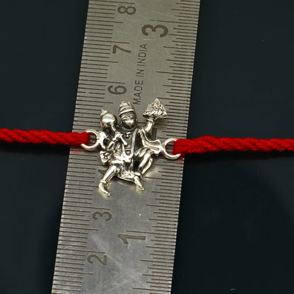 Sterling silver Flying Hanuman idol design bracelet with red thread rakhi from Tribal Ornaments, featuring intricate Hanuman figure.
