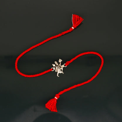 Sterling silver Flying Hanuman bracelet with red thread rakhi, featuring detailed idol god design by Tribal Ornaments.