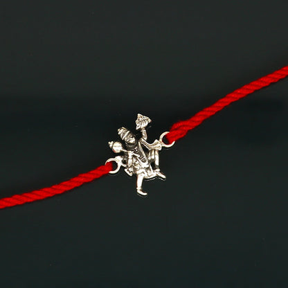 Sterling silver Flying Hanuman idol bracelet with red thread rakhi, traditional Tribal Ornaments design for Raksha Bandhan celebration.