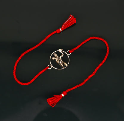 925 sterling silver Hanuman idol bracelet with red thread rakhi from Tribal Ornaments, featuring intricate design and vibrant red thread.