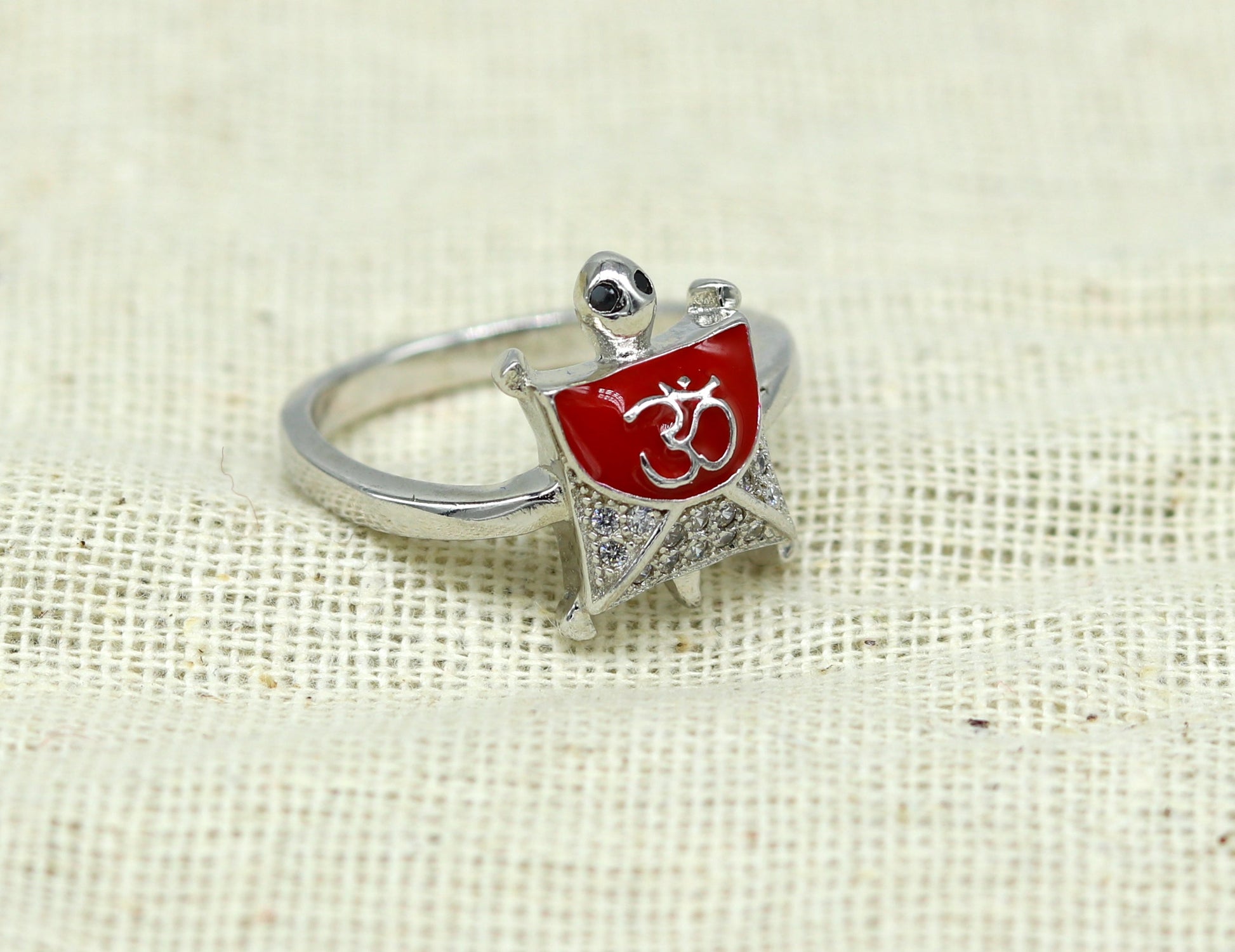 Red 925 Sterling silver tortoise ring with OM symbol, elegant unisex design, featuring a sparkling AD stone, from Tribal Ornaments.