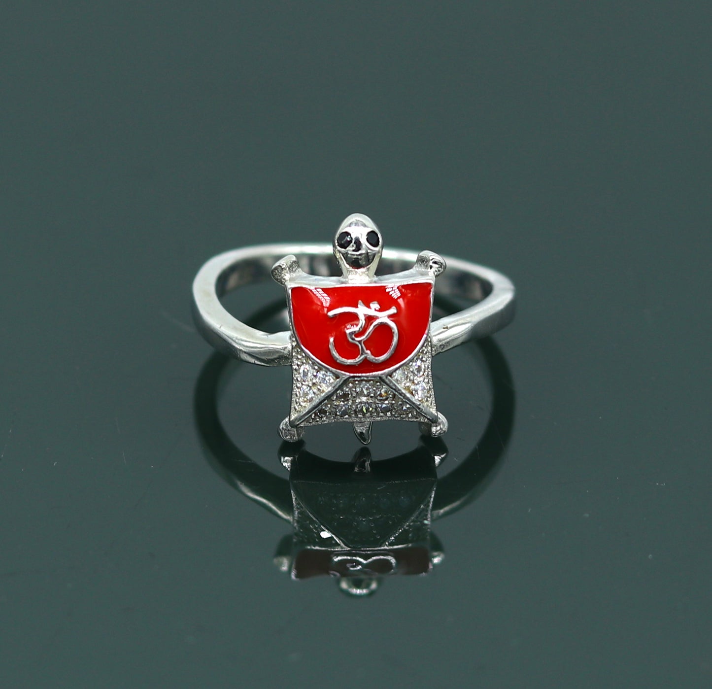 Red 925 sterling silver tortoise ring with OM blessing symbol, featuring an AD stone, elegant unisex jewelry by Tribal Ornaments.