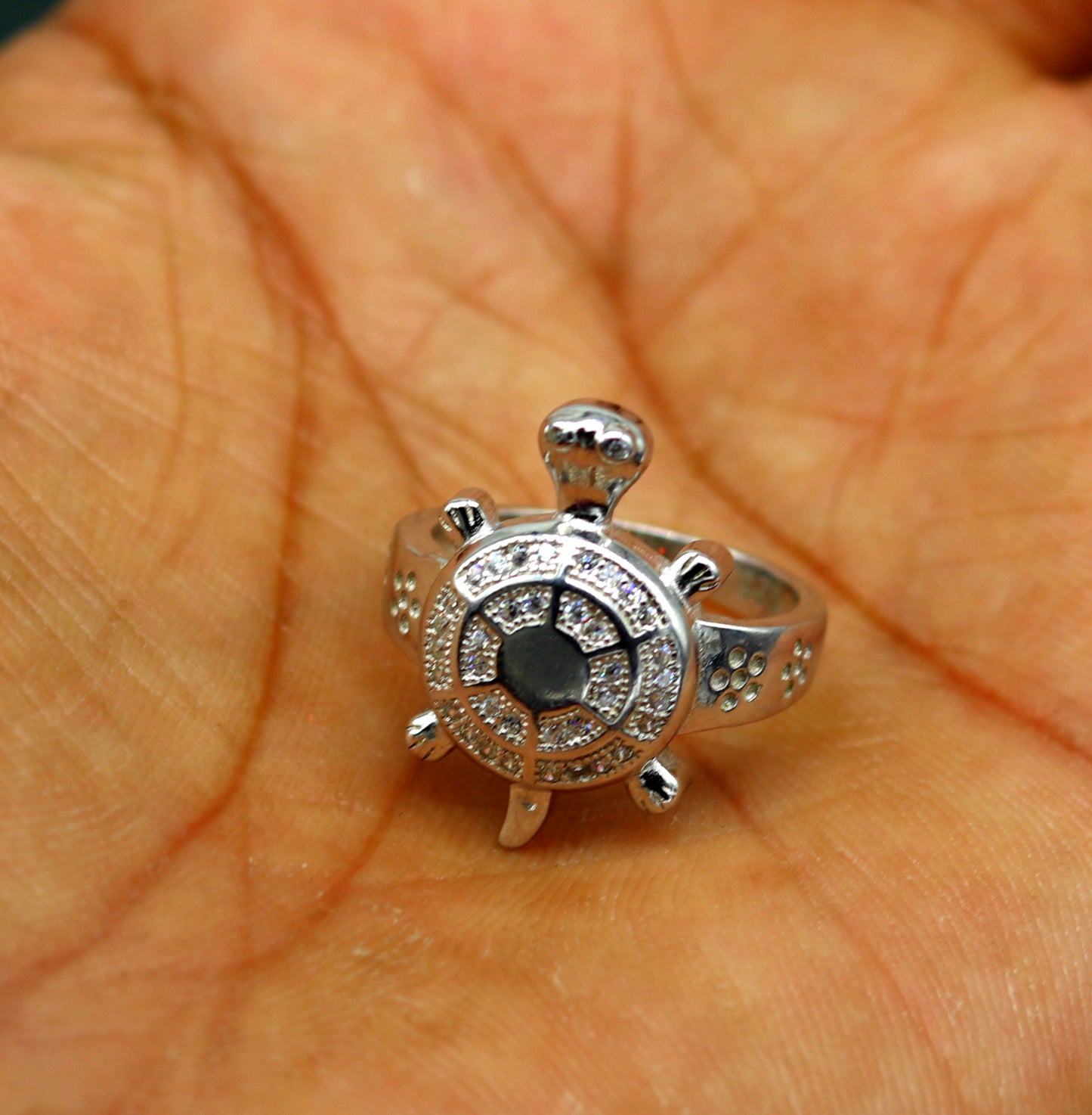 Sterling silver tortoise ring with AD stone, stylish unisex design, featuring intricate patterns and a polished finish.