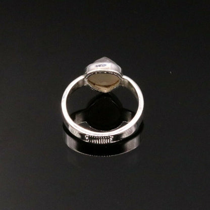 Handmade Indian sterling silver ring with stylish stone design, featuring intricate tribal ornament details and a band style.