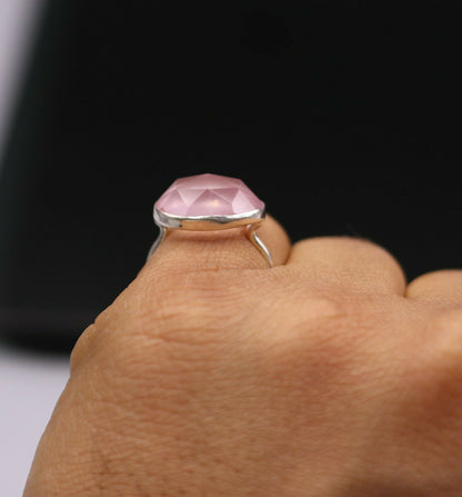 Unisex pink rose quartz ring with solid 925 silver band, handmade tribal ornament design, showcasing intricate craftsmanship.