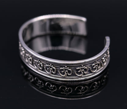 Handcrafted sterling silver or gold polished AUM mantra bangle bracelet, adjustable unisex ethnic jewelry from TRIBAL ORNAMENTS.