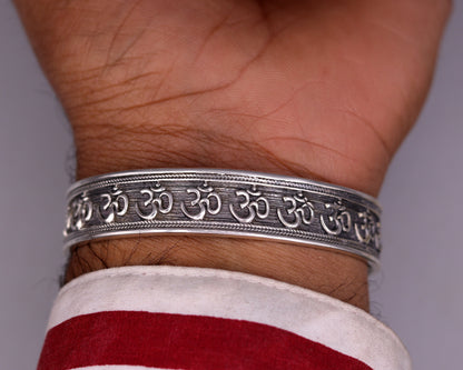 Polished 925 sterling silver or gold handcrafted 'AUM' mantra bangle bracelet, adjustable unisex ethnic jewelry with intricate design.