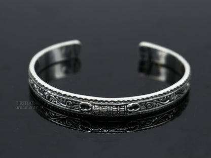 Handmade vintage-style tribal bangle bracelet in sterling silver or gold polish, featuring intricate tribal design.