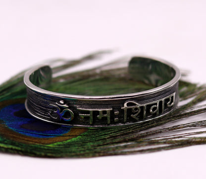 Sterling silver handmade cuff bracelet with "Aum namah shivay" open face design, polished silver or gold finish, by Tribal Ornaments.