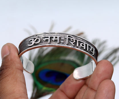 Sterling silver handmade cuff bracelet with "Aum Namah Shivay" open face design, polished silver or gold, by Tribal Ornaments.