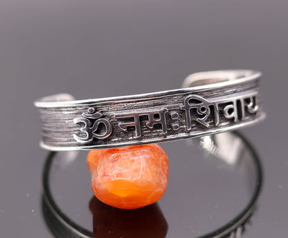 Sterling silver handmade open face cuff bracelet featuring "Aum namah shivay" design, polished silver or gold finish, tribal ornaments brand