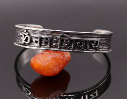Sterling silver open face cuff bracelet with Aum namah shivay design, handmade by Tribal Ornaments, polished in silver or gold finish.