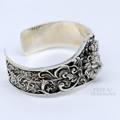 Sterling silver lion cuff bracelet by TRIBAL ORNAMENTS, handmade with polished silver or gold finish, featuring intricate lion design.