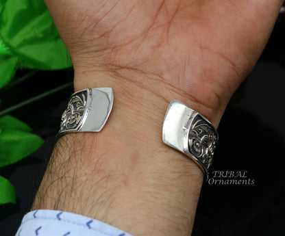 Sterling silver lion cuff bracelet by Tribal Ornaments, handmade with polished silver or gold finish, featuring intricate lion design.