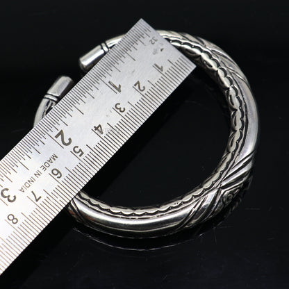Sterling silver chitai work unisex bangle bracelet with customized design, featuring intricate tribal ornament details.