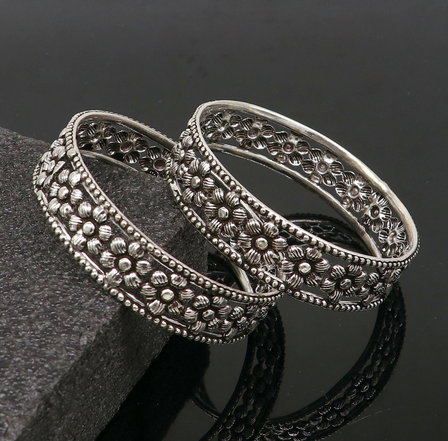 Sterling silver wide floral design bangle bracelet by TRIBAL ORNAMENTS, showcasing intricate ethnic jewelry for brides or stylish wear.