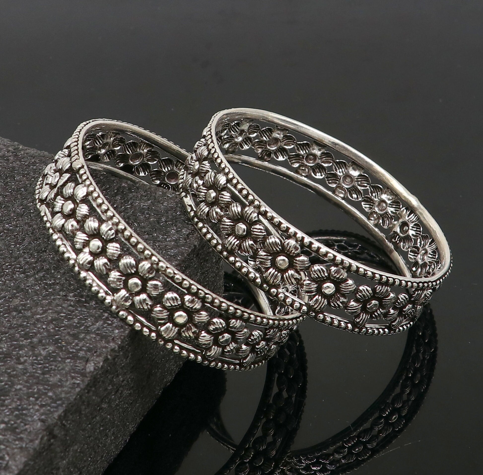 Sterling silver wide floral design bangle bracelet by TRIBAL ORNAMENTS, showcasing intricate ethnic jewelry for brides or stylish wear.