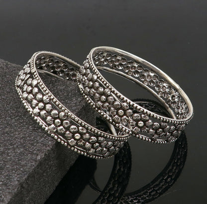Sterling silver wide floral design bangle bracelet by TRIBAL ORNAMENTS, showcasing intricate ethnic jewelry for brides or stylish wear.