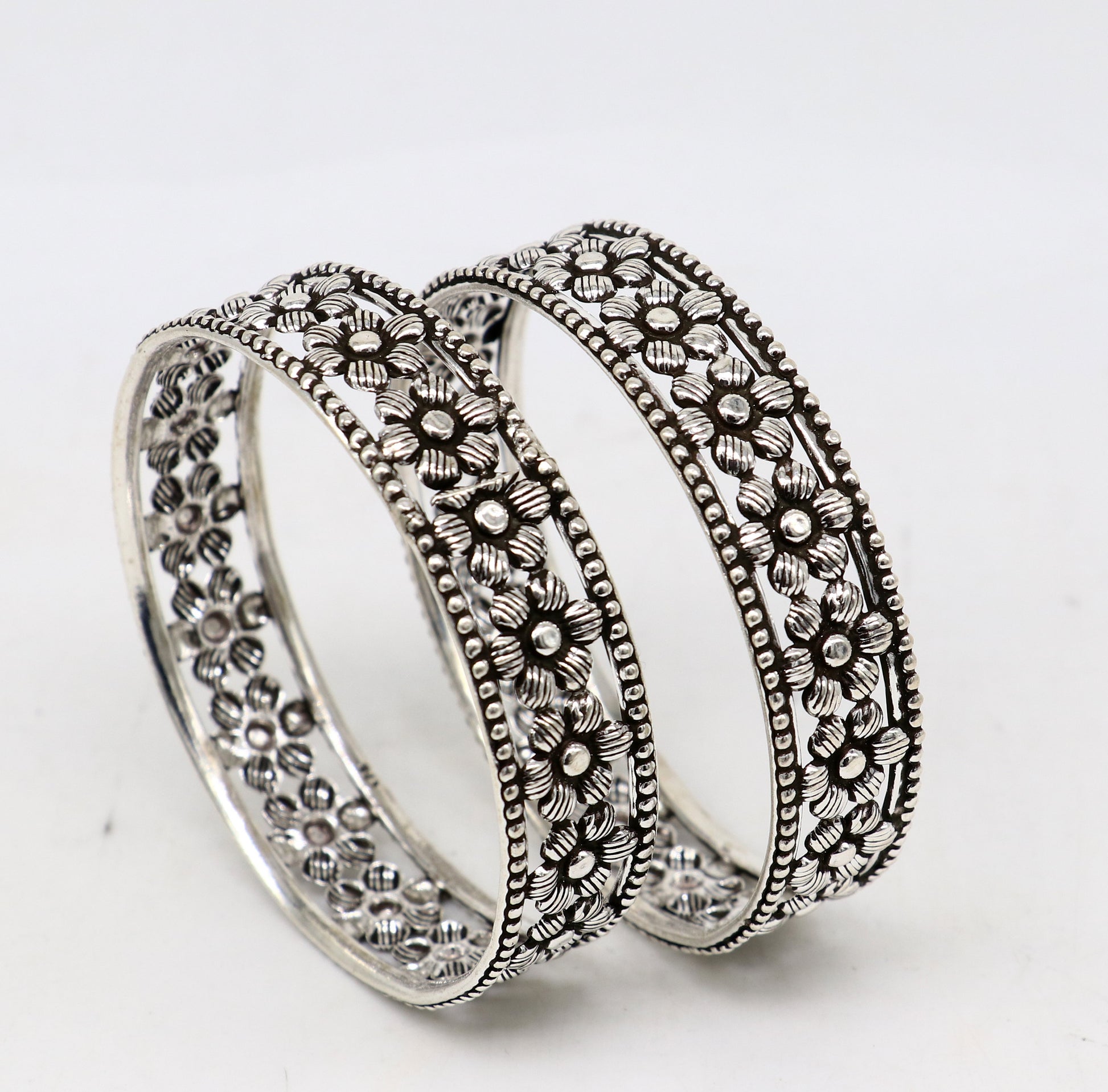 Sterling silver tribal bangle bracelet with wide floral design, customized and stylish ethnic jewelry for brides and special occasions.