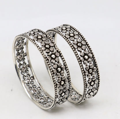 Sterling silver tribal bangle bracelet with wide floral design, customized and stylish ethnic jewelry for brides and special occasions.