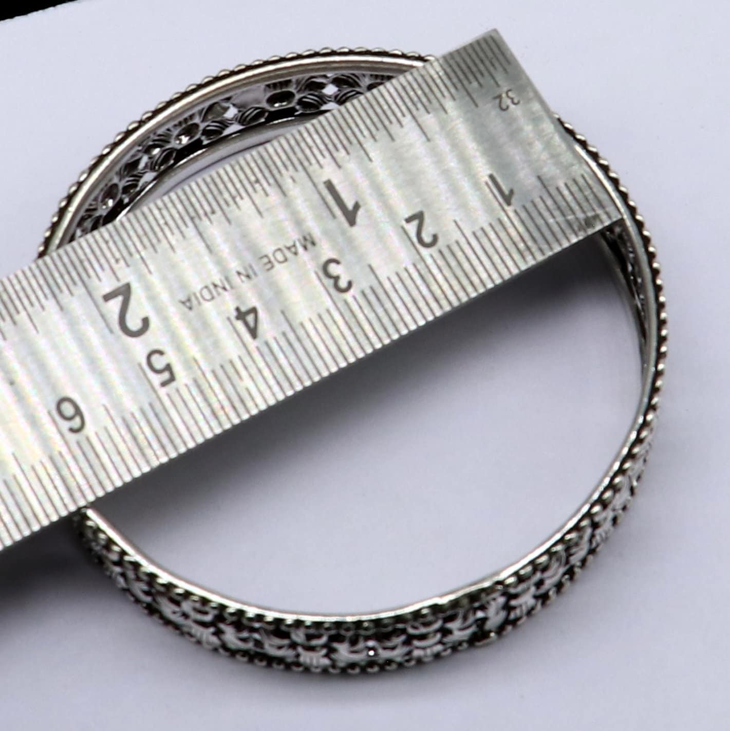Sterling silver wide floral design bangle bracelet by TRIBAL ORNAMENTS, showcasing intricate ethnic craftsmanship and stylish jewelry.