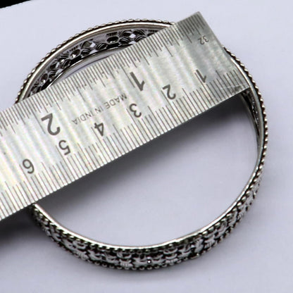 Sterling silver wide floral design bangle bracelet by TRIBAL ORNAMENTS, showcasing intricate ethnic craftsmanship and stylish jewelry.