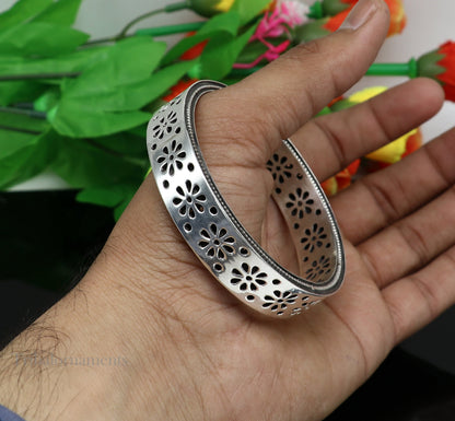 Sterling silver floral bangle bracelet by TRIBAL ORNAMENTS with vintage design, featuring intricate floral details for brides.