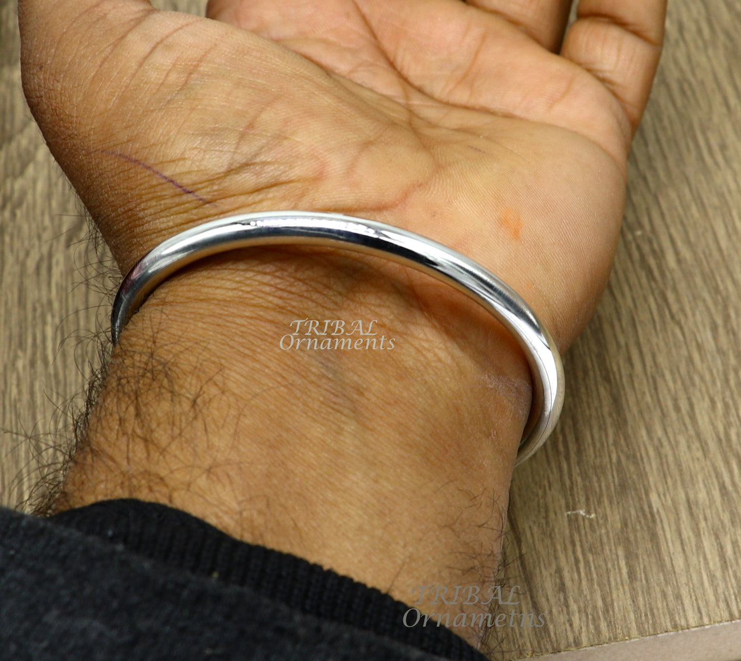 Handmade 925 sterling silver bangle bracelet with a shiny, plain finish, personalized unisex jewelry by Tribal Ornaments.